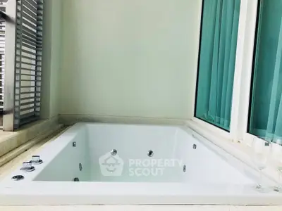 Luxurious private jacuzzi on a serene balcony with modern design and glass accents.