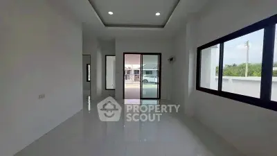 Spacious modern living room with large windows and glossy tile flooring
