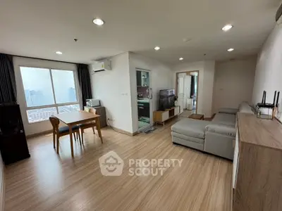 Spacious modern living room with dining area and city view