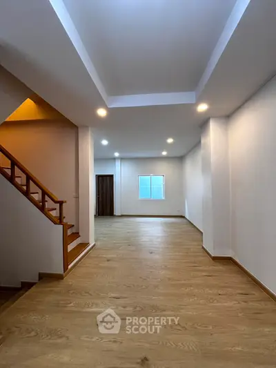 Spacious modern living room with wooden flooring and recessed lighting