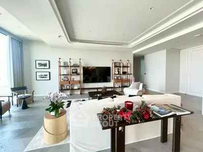 Luxurious living room with elegant decor and large windows offering natural light