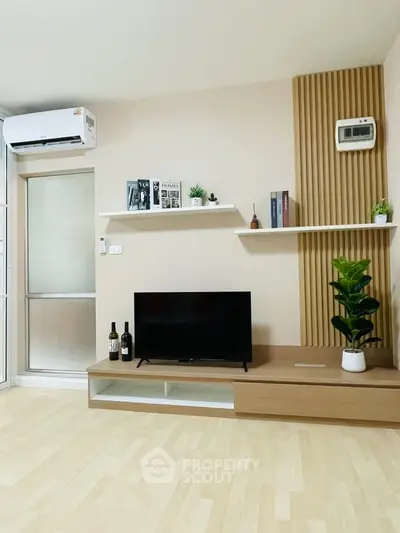 Modern living room with sleek TV stand, stylish shelves, and air conditioning unit.