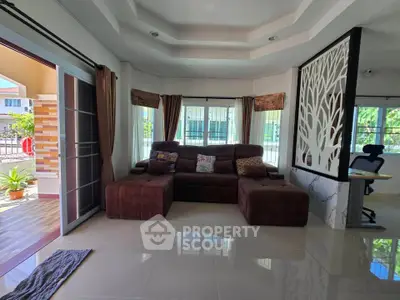 Spacious living room with modern decor and large windows for natural light