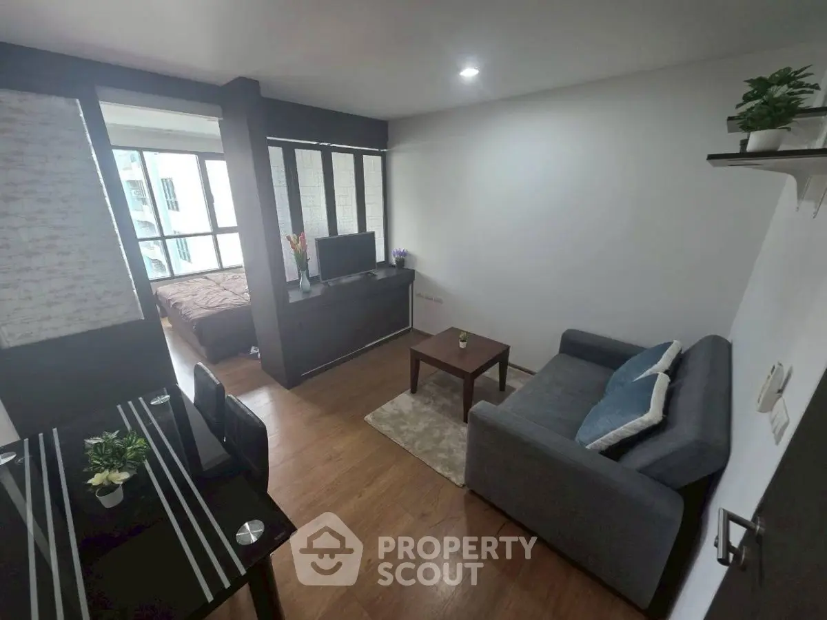 Modern living room with cozy sofa and dining area in a stylish apartment.