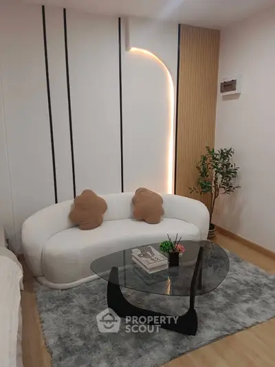 Stylish modern living room with cozy white sofa and elegant glass coffee table