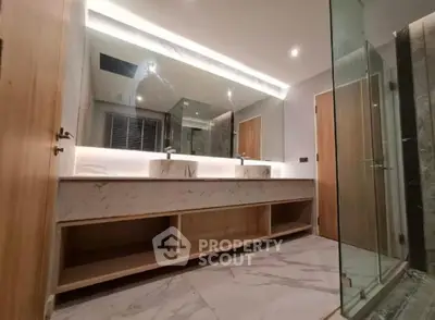 Luxurious modern bathroom with dual sinks and elegant marble finishes.