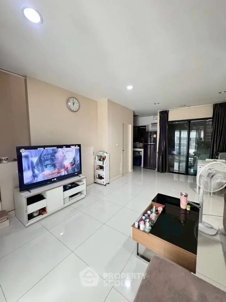 Modern living room with sleek white tiles and stylish furniture