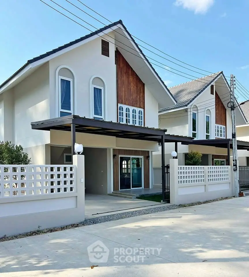 Modern two-story house with stylish facade and spacious driveway in a serene neighborhood.