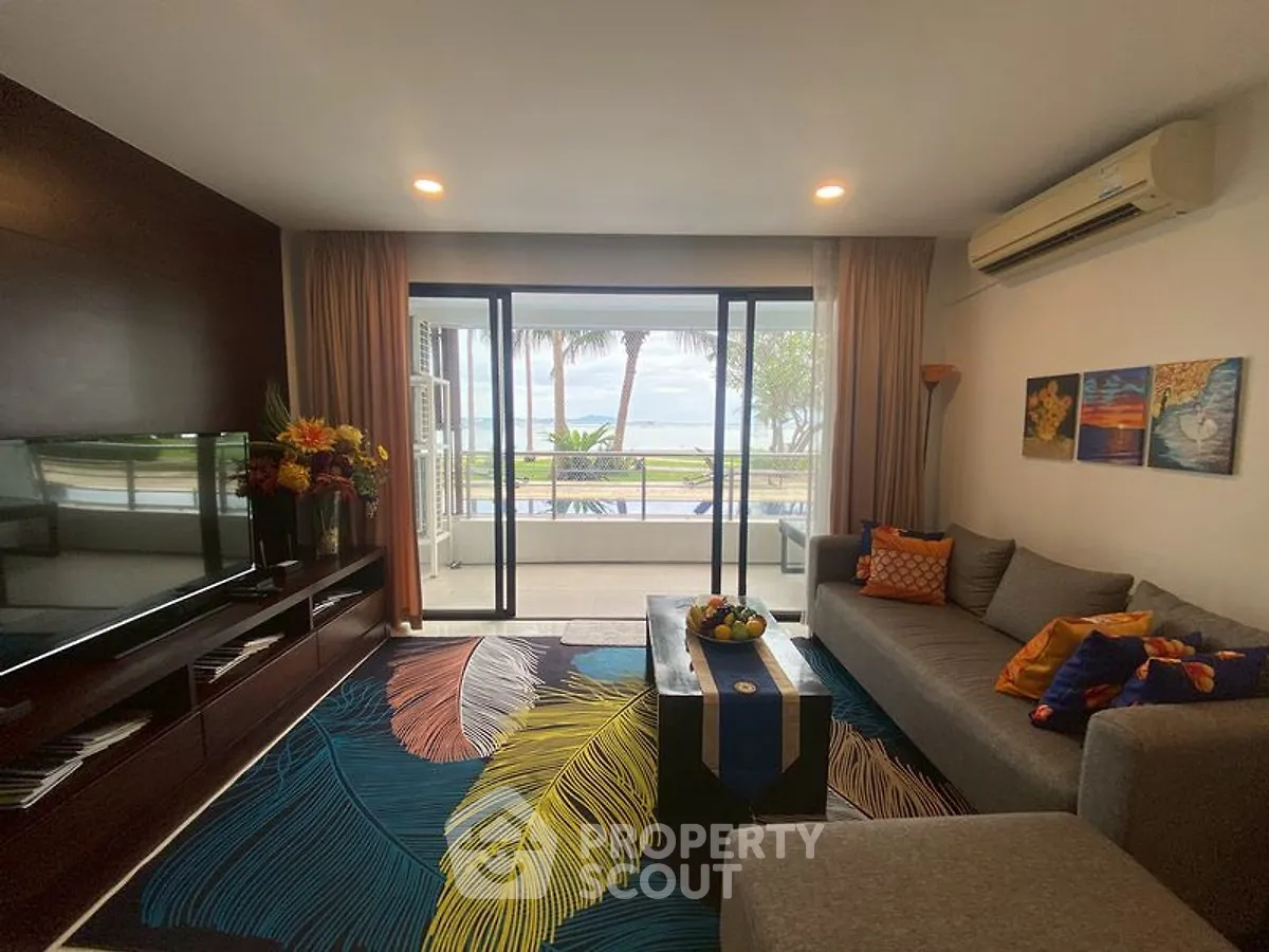 Stylish living room with ocean view, modern decor, and vibrant accents.