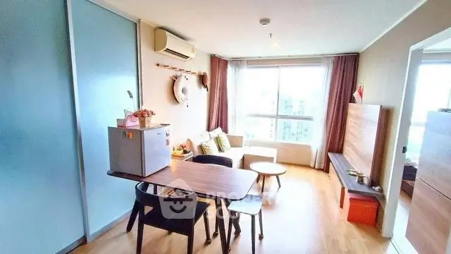 Bright and modern living room with stylish furniture and large window view.
