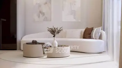 Elegant modern living room with stylish curved sofa and chic coffee tables.