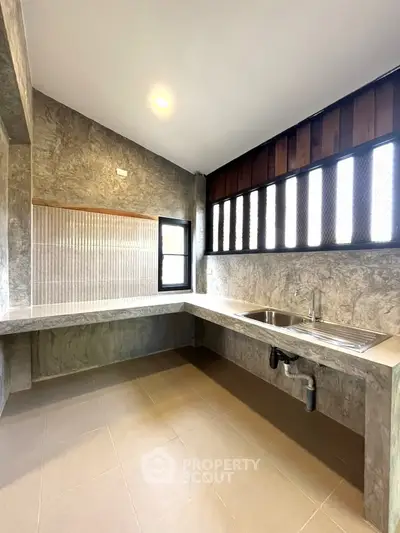 Modern kitchen with sleek countertops and ample natural light