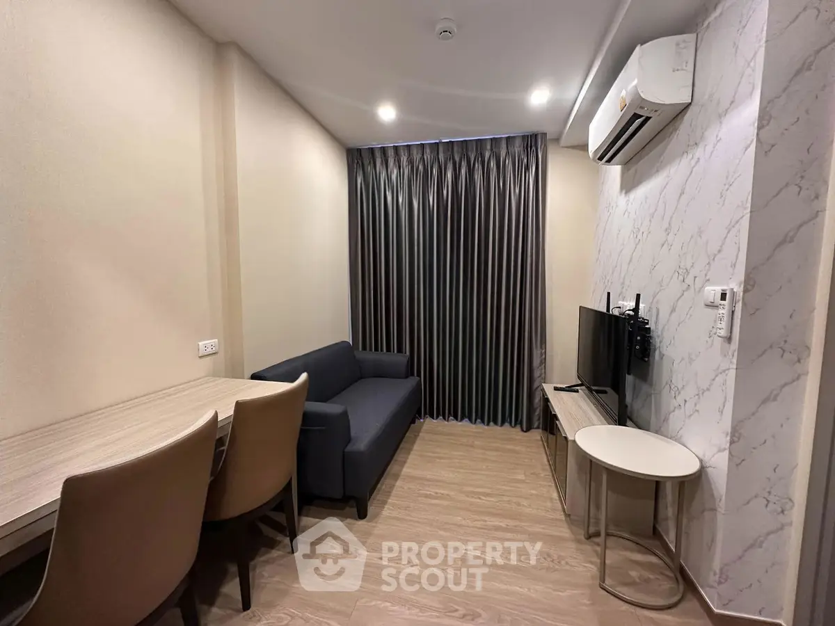 Modern living room with sleek furniture and air conditioning in a stylish apartment.