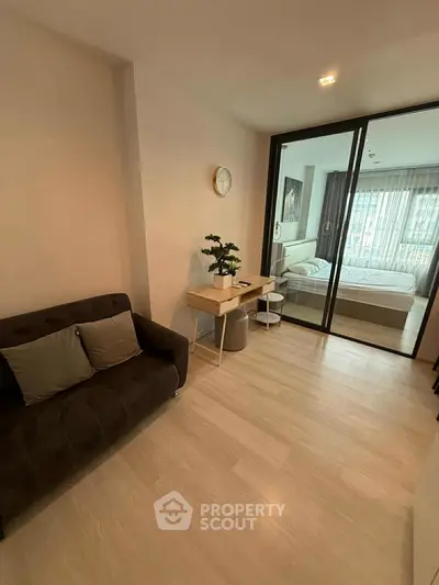 Modern apartment interior with cozy living area and stylish bedroom view.