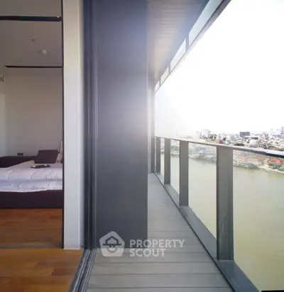 Stunning river view from modern high-rise apartment balcony with sleek design.