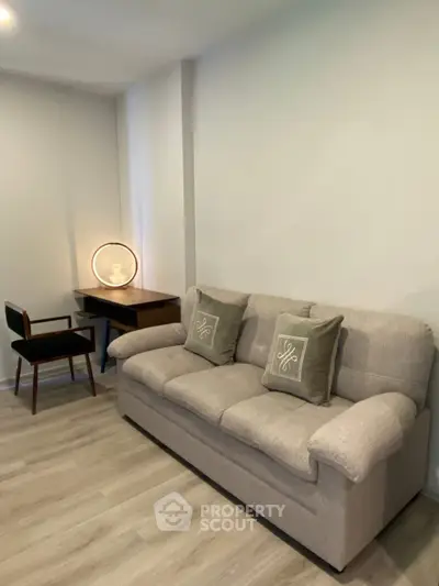 Cozy living room with stylish sofa and modern desk lamp