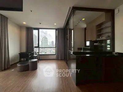 Modern open-layout living room with city view and sleek kitchen design