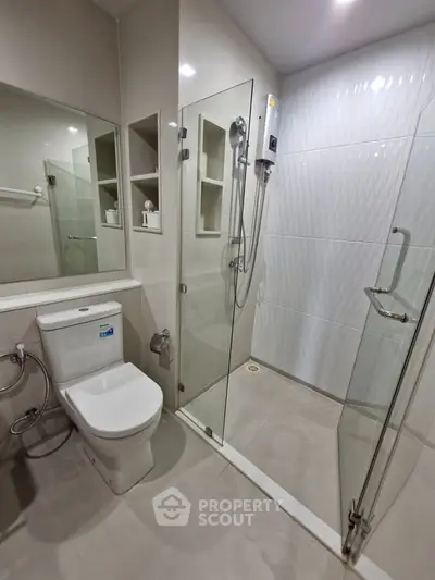 Modern bathroom with glass shower enclosure and sleek fixtures