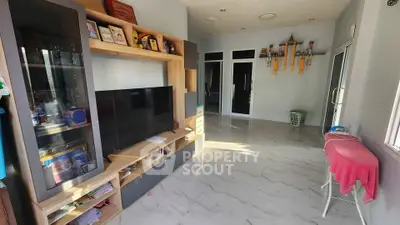 Spacious living room with modern entertainment center and natural light