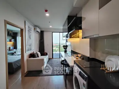 Modern open-plan living room with kitchen and balcony view