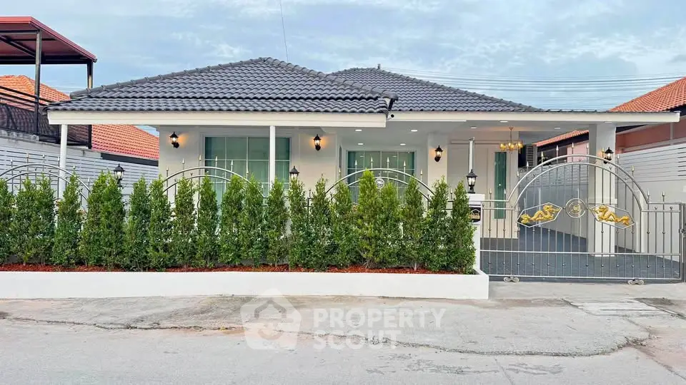 Charming single-story home with modern design, lush greenery, and secure gated entrance.