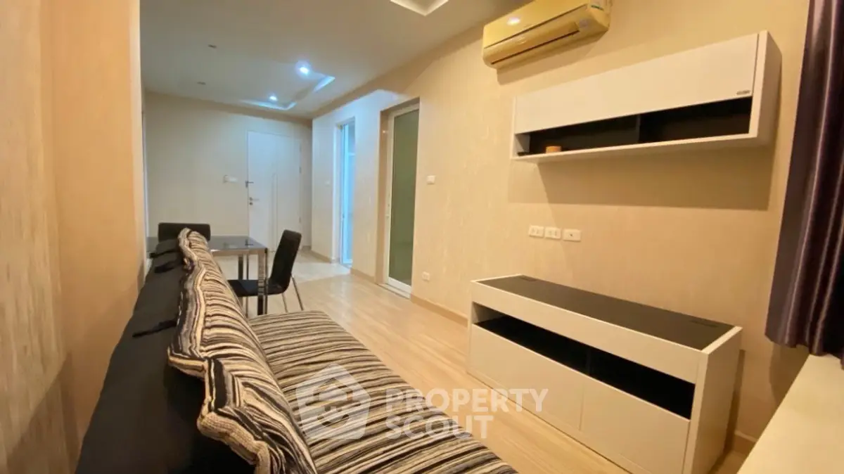 Modern living room with striped sofa and sleek furniture in cozy apartment