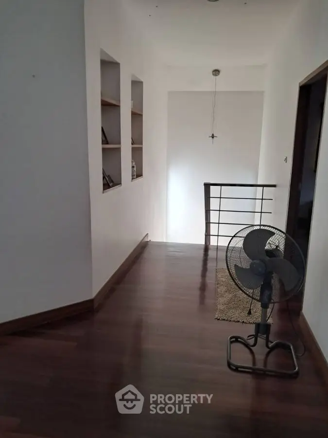 Spacious hallway with wooden flooring and modern decor