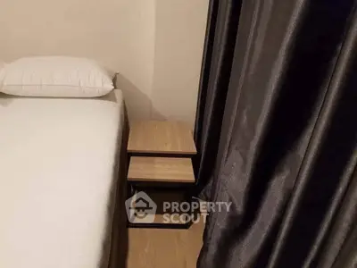 Cozy bedroom corner with modern nightstand and elegant curtains