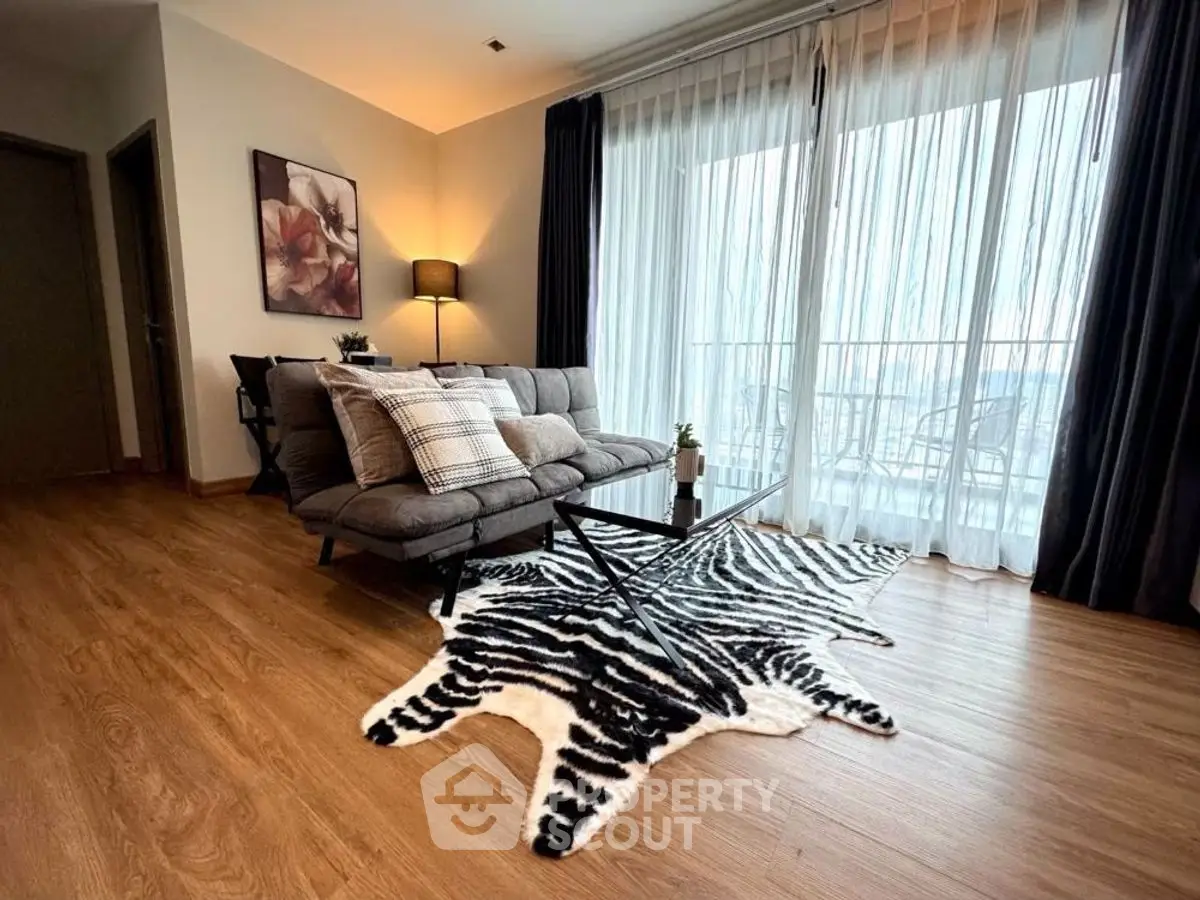 Stylish living room with zebra rug and cozy sofa near large window.