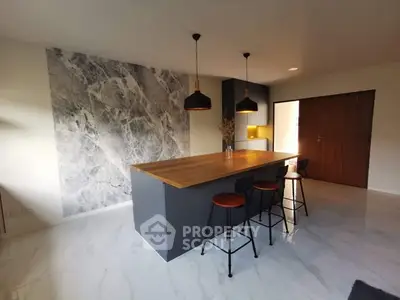 Modern kitchen with marble accent wall and sleek island design