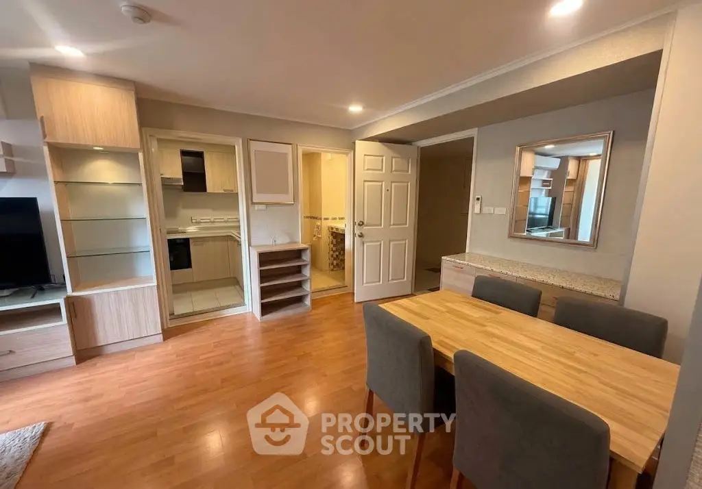 Spacious open-plan living room with modern dining area and wooden flooring.