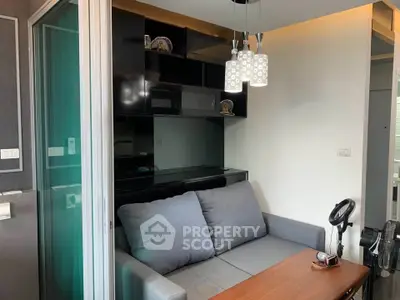 Modern living room with sleek black shelving and cozy gray sofa