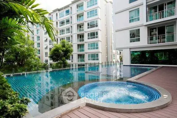 Luxurious apartment complex with stunning pool and jacuzzi area
