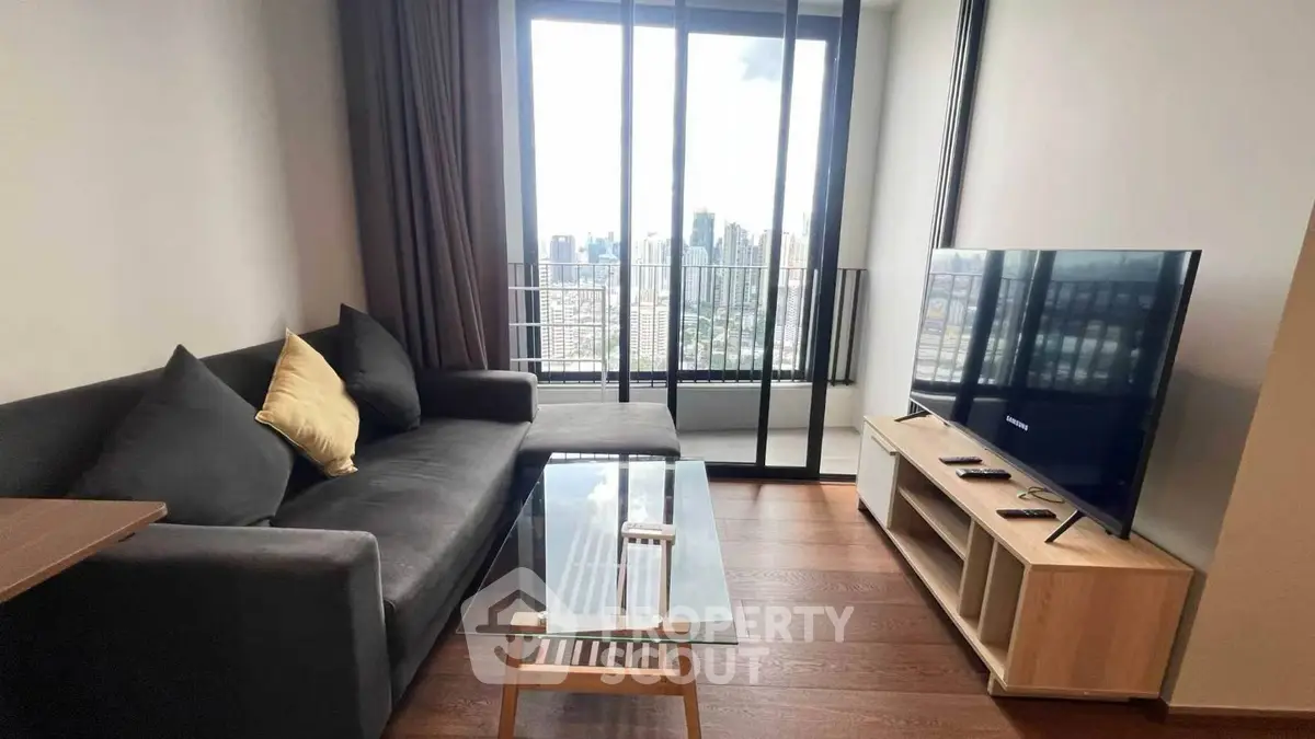 Modern living room with city view, sleek furniture, and large windows in urban apartment.
