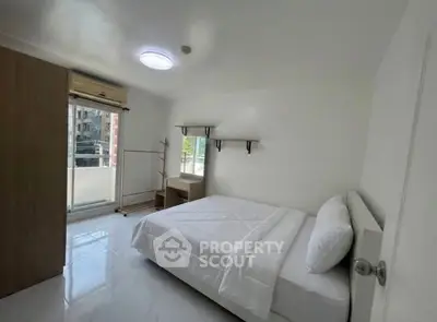 Bright and modern bedroom with large window and minimalist decor