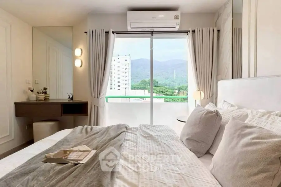 Cozy bedroom with mountain view, modern decor, and natural light through large window.