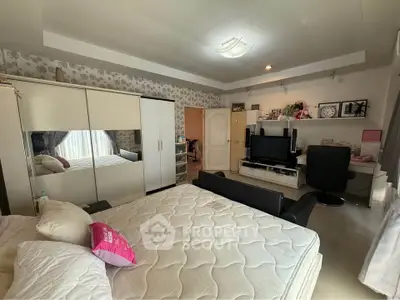 Spacious bedroom with modern decor and ample natural light
