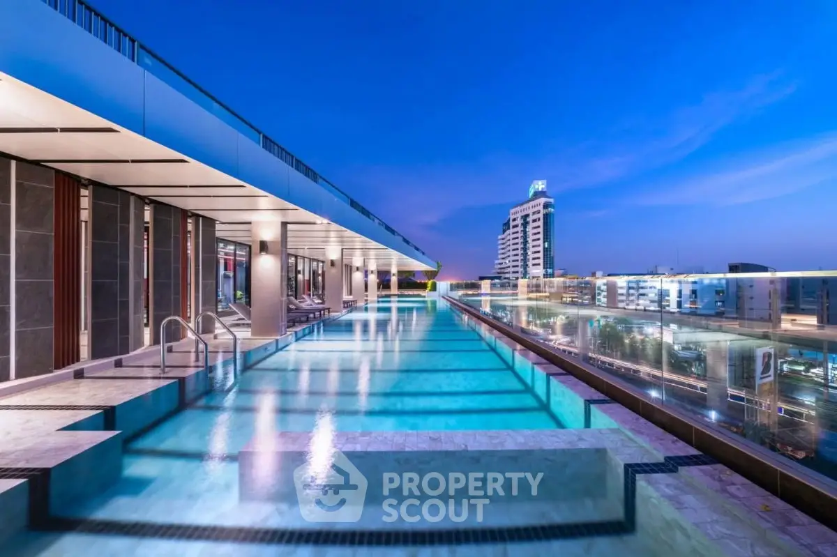 Luxurious rooftop pool with stunning city views at sunset
