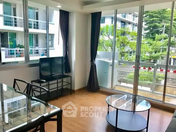 Modern living room with large windows and natural light in a stylish apartment.