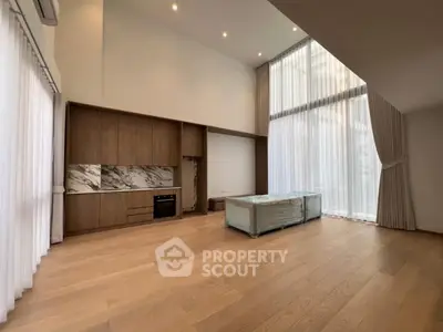 Spacious modern living room with high ceilings and large windows