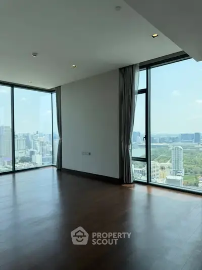 Spacious corner unit with panoramic city views and floor-to-ceiling windows.