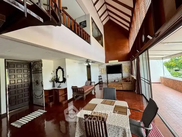 Spacious living room with high ceilings and large balcony access