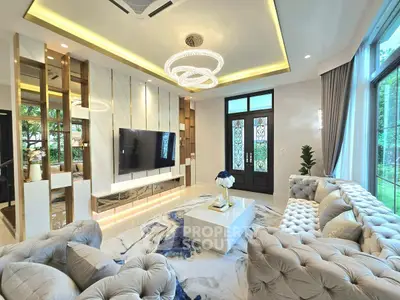 Luxurious living room with elegant decor and large windows offering garden views.