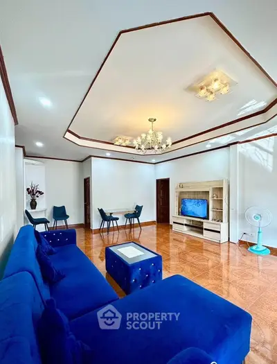 Spacious living room with elegant blue sofa and modern decor