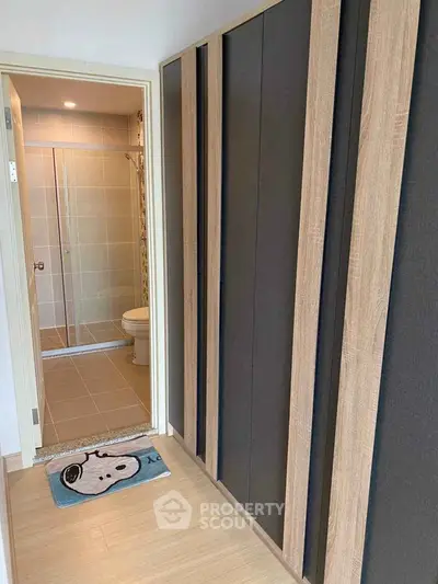 Modern bathroom entrance with sleek wardrobe and stylish flooring