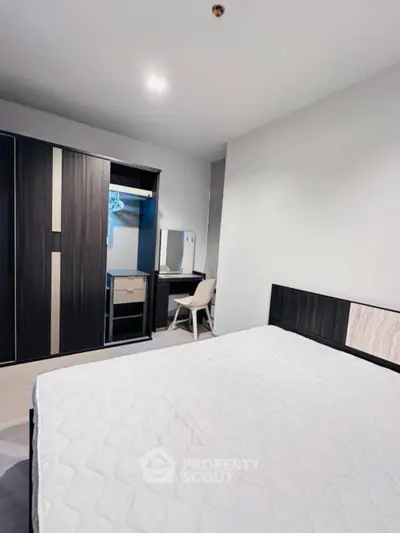 Modern bedroom with sleek wardrobe and minimalist decor, perfect for urban living.