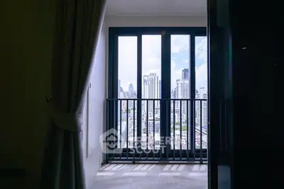 Stunning city view from a modern apartment balcony with floor-to-ceiling windows.