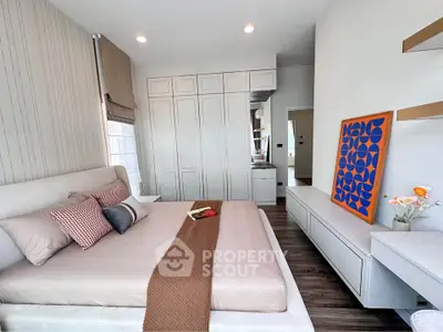 Modern bedroom with stylish decor and ample natural light