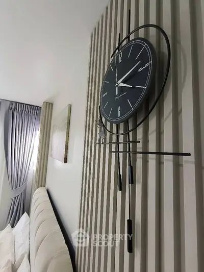 Modern bedroom with stylish wall clock and elegant decor