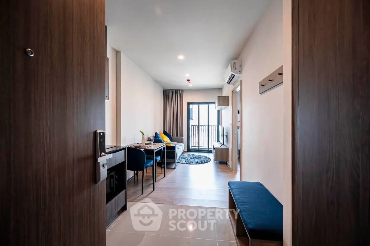 Modern living room with balcony view, stylish furniture, and open layout in a contemporary apartment.